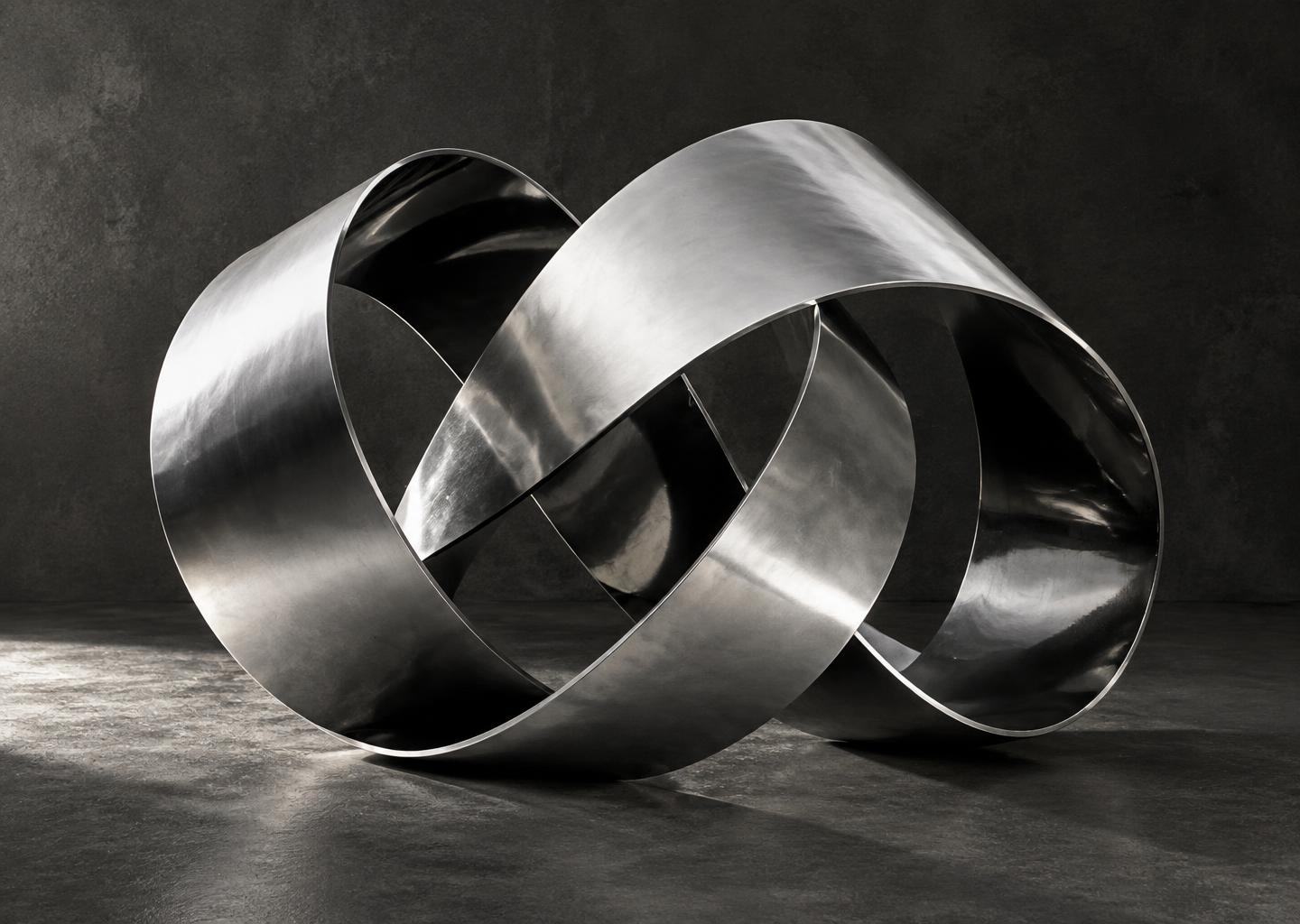 A continuous chrome ribbon folded into a sculptural knot