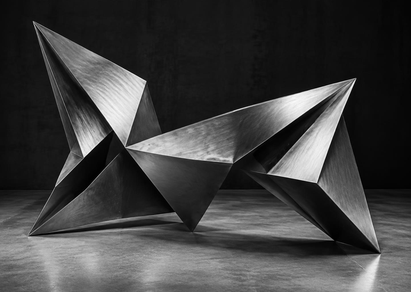 Sharp folded aluminum planes forming an angular abstract sculpture